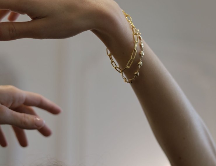 Pulseras de oro 18K combinadas en capas sobre la muñeca, estilo layering