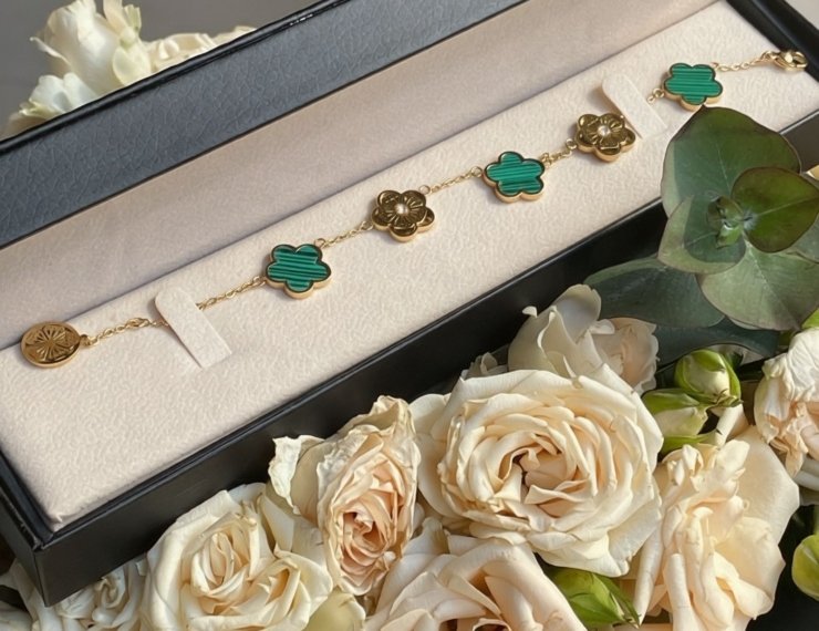 Joyería de oro 18K en estuche elegante rodeado de rosas, guía de regalos